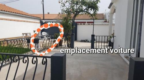 an orange and white embrace sign on a fence at Les Belous in La Rochelle