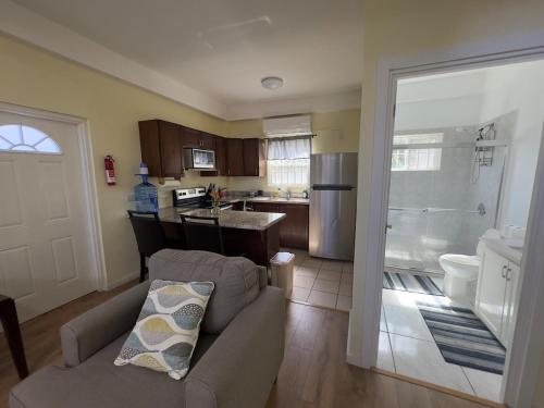 a living room with a couch and a kitchen at Itopia in Gros Islet