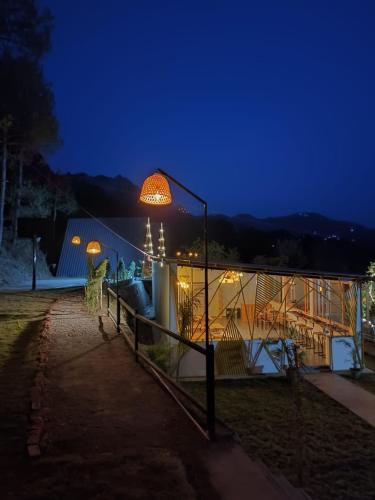 a view of a house at night at Paradise Pool Resort in Nainital