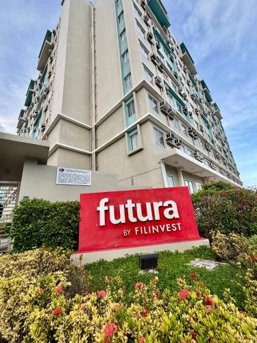 a hotel sign in front of a tall building at Dumaguete Marina Spatial Condo Unit in Dumaguete