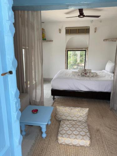 a bedroom with a bed and a blue table at Rana Mahal - a Boutique Place in Varanasi
