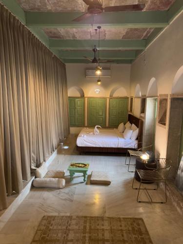 a bedroom with a bed and a table in it at Rana Mahal - a Boutique Place in Varanasi