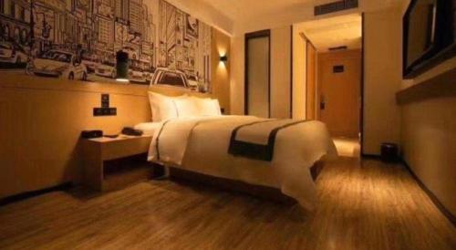 a hotel room with a large bed and a desk at City Comfort Inn Changsha South Railyway Station West Square in Changsha