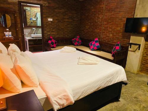 a bedroom with a large white bed in a room at Aayu Hanthana Boutique Hotel in Kandy