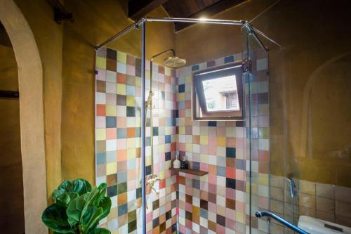 a bathroom with a shower with colorful tiles at Hoi An Hidden Boat in Hoi An