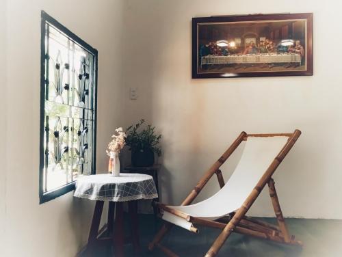 a rocking chair and a table in a room at roc rach homestay in Ấp Tân Hà