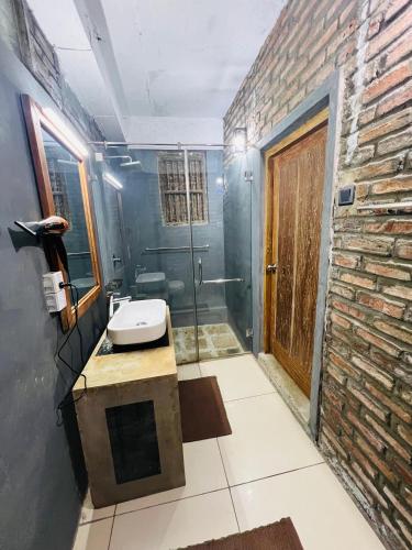 a bathroom with a sink and a shower at Aayu Hanthana Boutique Hotel in Kandy