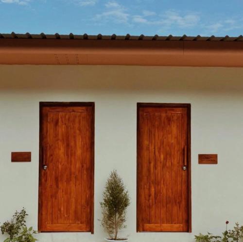 two doors on the side of a house at ViewNaaBaan At Phamee in Ban Pha Mi