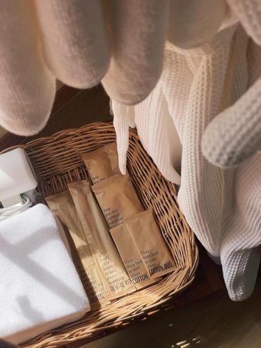 a basket filled with towels and a blanket at ViewNaaBaan At Phamee in Ban Pha Mi