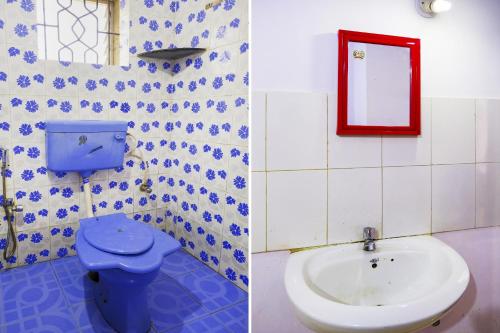 a bathroom with a toilet and a sink at Hotel O Mahamaya Holiday Inn in Goa