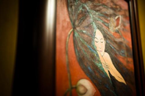 a picture of a painting of a woman at Hoi An Hidden Boat in Hoi An