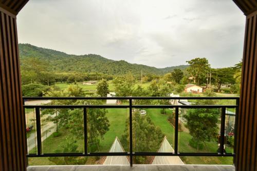 a room with a window with a view of a mountain at Take Time Nature Resort in Ban Tha Sai