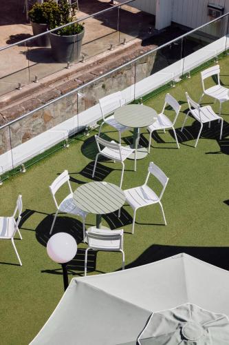 a group of tables and chairs sitting on the grass at Lorne Hotel in Lorne