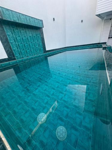 a swimming pool with blue water in a building at Oasis Hotel in San Andrés