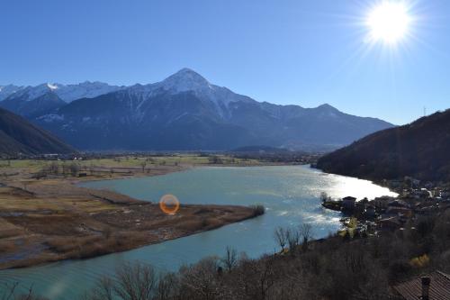 a view of a river with mountains in the background at Appartamento Country House Menaggio in Menaggio