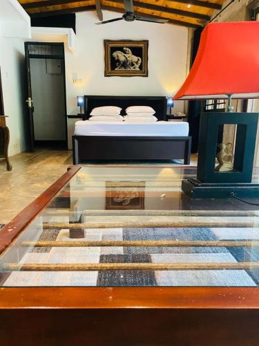 a bedroom with a bed and a glass table at Aayu Hanthana Boutique Hotel in Kandy