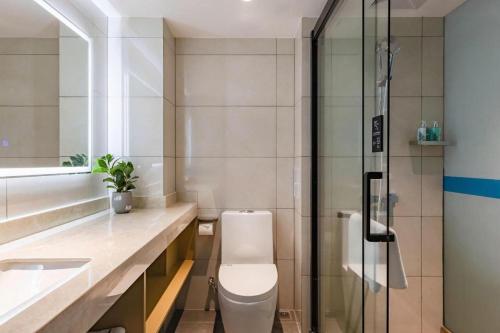 a bathroom with a toilet and a sink and a shower at City Comfort Inn Kunming Dashuying Yejin Hospital Wangdaqiao in Kunming