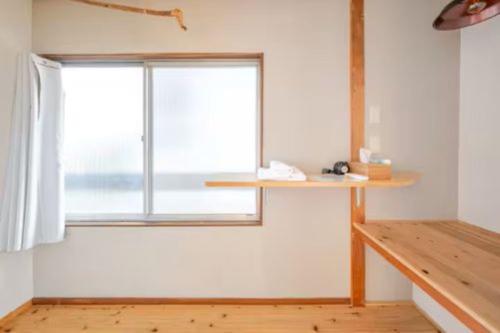 a room with a window and a wooden table at Guesthouse giwa - Vacation STAY 14271v in Mishima