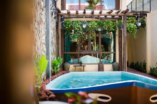 a jacuzzi tub in the middle of a building at Hoi An Hidden Boat in Hoi An
