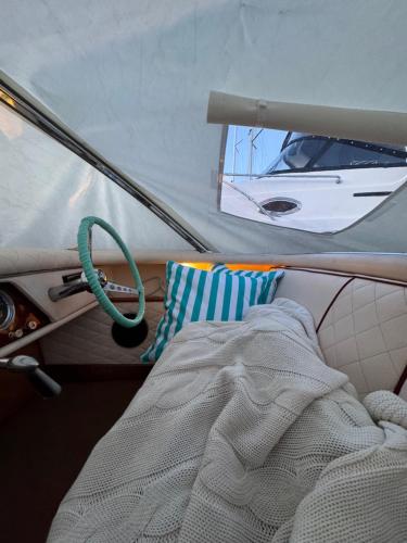 a bed in a boat with a sail and a mirror at Sopot Classic Boat in Sopot