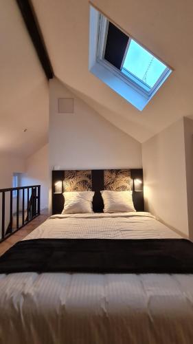 une chambre avec un grand lit avec une fenêtre dans l'établissement Maison de ville Proche Disneyland Paris, à Montry