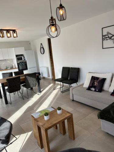 un salon avec un canapé et une table dans l'établissement PLOERMEL Centre- Gite touristique 3 étoiles- 2 SdeBain, à Ploërmel