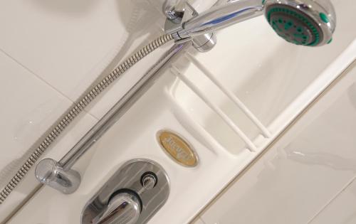 a bathroom sink with a faucet and a shower at Hotel Gabbiano in Cattolica