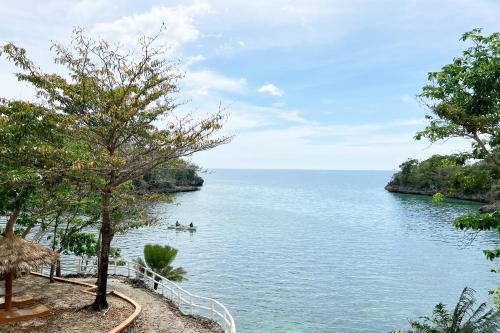 a view of a body of water with two people in a boat at La Puerta Al Paraizo Guimaras powered by Cocotel in Guimaras
