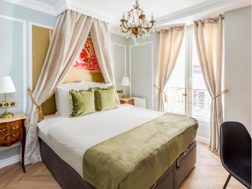 une chambre avec un grand lit et un lustre dans l'établissement Merveil - Luxury Suite - Louvre - Aboukir VII, à Paris