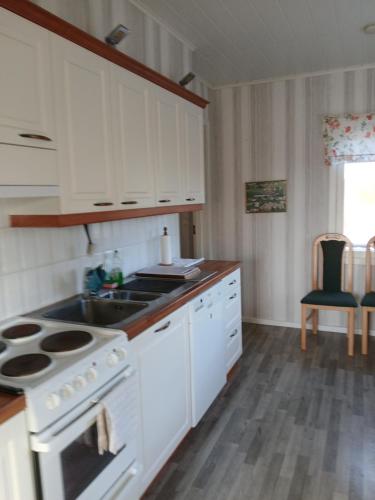 a kitchen with a stove and a sink at Detached house with everything you need in Dagsmark