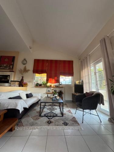 a living room with a bed and a table at Sunny Garden villa in Plataria