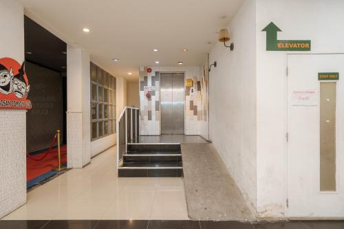 a hallway of a building with stairs and a elevator at Collection O Khaosan Park in Bangkok