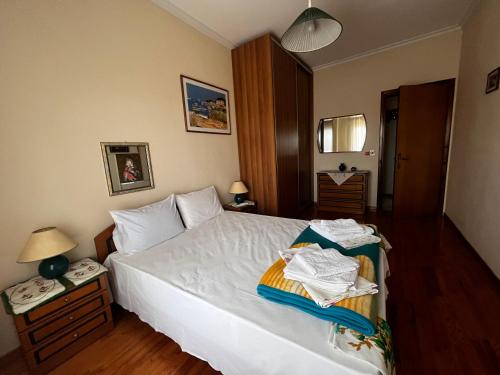 a bedroom with a bed with towels on it at Karitsa's Holiday Home in Karítsa