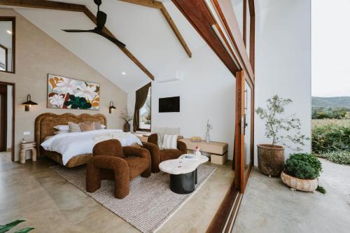 a bedroom with a large bed and some chairs at Kavillo Studios in Buckaroo