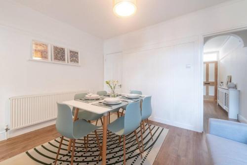 a dining room with a table and chairs at Westfield Town-House Free Parking, Secure Garden in Caversham