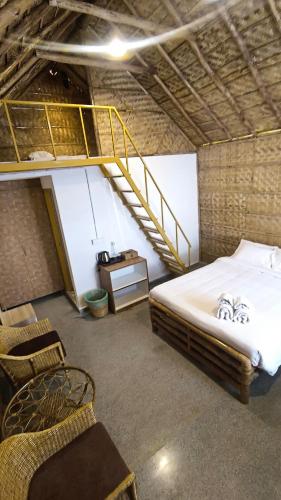 a bedroom with a bunk bed and a staircase at Maharsh Bamboo Stays near Devanahalli in Dod Jāla