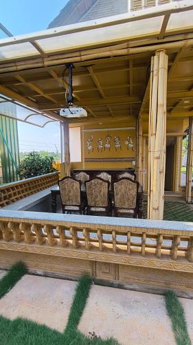 a group of chairs sitting on a patio at Maharsh Bamboo Stays near Devanahalli in Dod Jāla