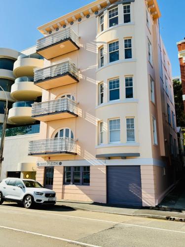 a building with a car parked in front of it at Historical 2 beds apartment with Harbour Views in OBay in Wellington