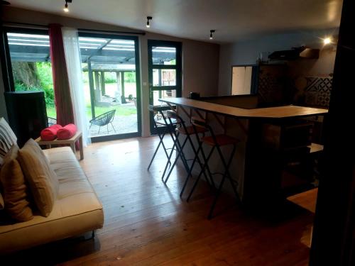 a living room with a table and a couch at La Villa Saint Ghislain in Thivencelle