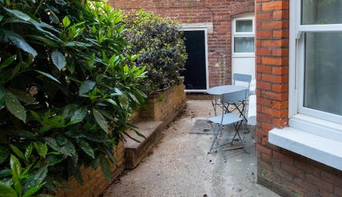 a table and chairs in front of a building at The Beach Way- specious Apt in Eastbourne