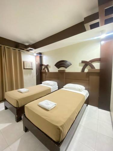 a room with two beds in a room at Sonly Hotel in General Santos
