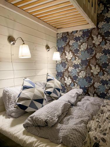 a bedroom with a bed with pillows on it at Sillvik C&J Hugosson in Sanden