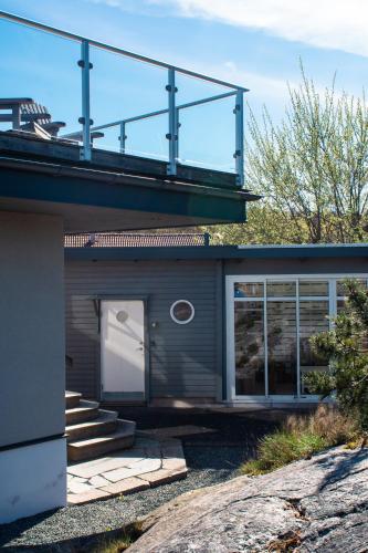 a house with a balcony on top of it at Sillvik C&J Hugosson in Sanden