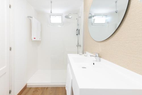 a bathroom with a white sink and a mirror at Olé Tropical Tenerife Adults Only in Playa de las Americas