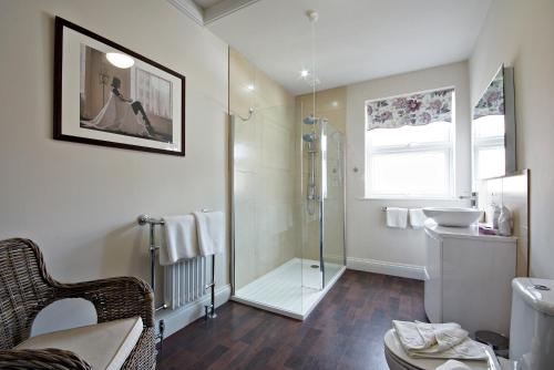 a bathroom with a shower and a sink at Bronte Guest House in York