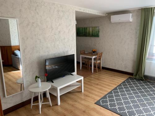 a living room with a television and a table at Nordes in Ragaciems