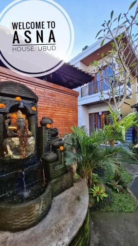 a water fountain in front of a house at Asna House in Ubud