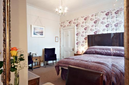 a bedroom with a bed and a desk and a chair at Bronte Guest House in York