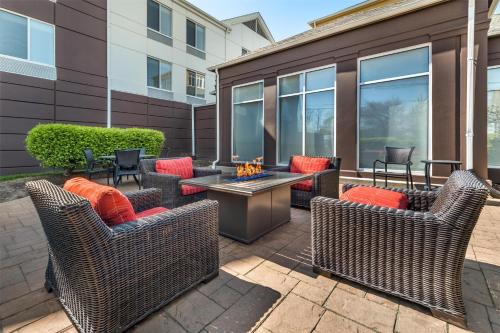 a patio with wicker chairs and a fire pit at Hilton Garden Inn Lexington in Lexington