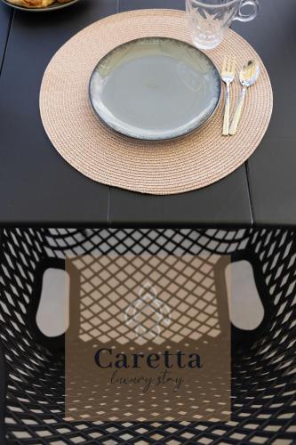 a table with a plate and a sign that readsaria happyay at Gem Villas Luxury Sea View in Karavadhos